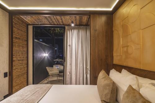 a bedroom with a bed and a sliding glass door at Golden Valley Hotel in Medellín