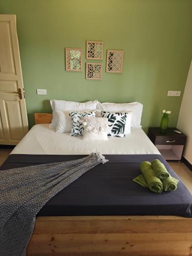 a bedroom with a large bed with pillows on it at SOLS Backyard in Arambol