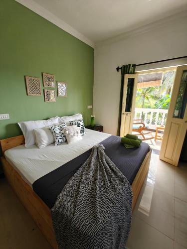 a bedroom with a large bed with pillows on it at SOLS Backyard in Arambol