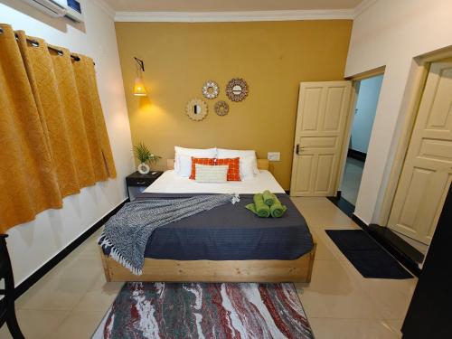 a bedroom with a large bed with orange pillows at SOLS Backyard in Arambol