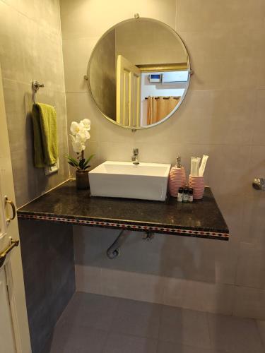 a bathroom with a sink and a mirror at SOLS Backyard in Arambol