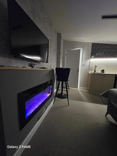 a living room with a flat screen tv on a wall at Face 3 Center SUBOTICA in Subotica