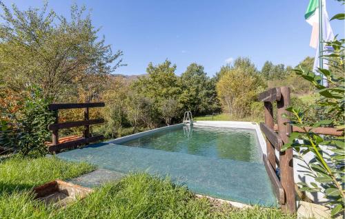 a pool of water with a fountain in the grass at 2 Bedroom Lovely Home In Sillano in Sillano
