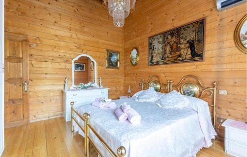 a bedroom with a bed with pink pillows on it at 2 Bedroom Lovely Home In Sillano in Sillano
