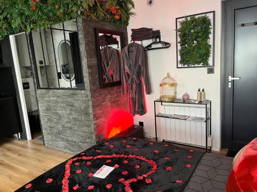 a room with a bed with red flowers on it at BelleRive Love Room in Publier