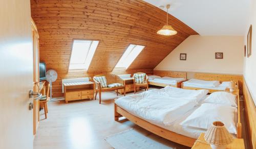 a bedroom with a large bed in a room with windows at Penzion Bene in Chotěboř