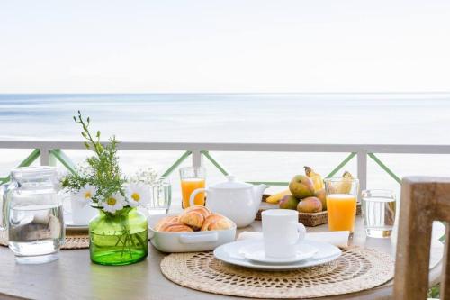 a breakfast table with a view of the ocean at Belle Coco Malgratoute Beach St Lucia in Soufrière