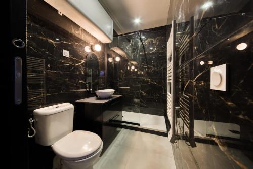 a black bathroom with a toilet and a sink at Cosy apartment - Near Paris - RER D in Villeneuve-Saint-Georges