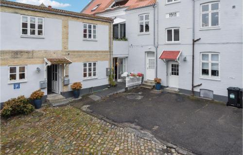 a group of white houses with a driveway at One-Bedroom Apartment In Stege in Stege