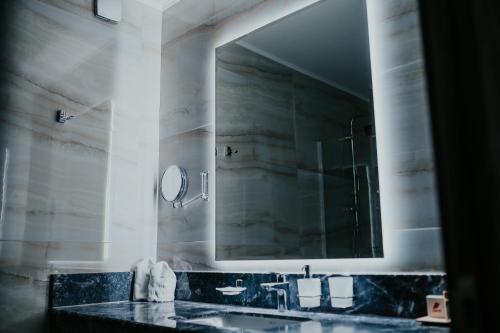 a bathroom with a sink and a mirror at Santé SPA Hotel in Velingrad