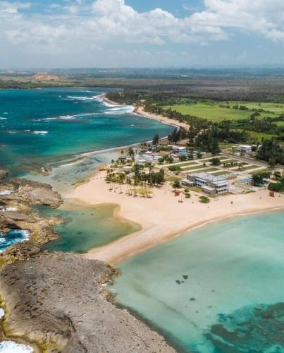 an aerial view of a beach and the ocean at A few steps from Mar Bella Beach, Vega Baja! in Vega Baja
