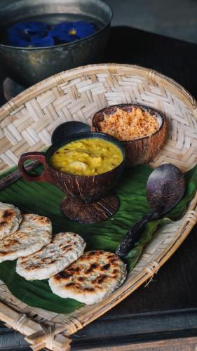 a basket of food with bowls of food on a table at Dunes Unawatuna Hotel in Unawatuna