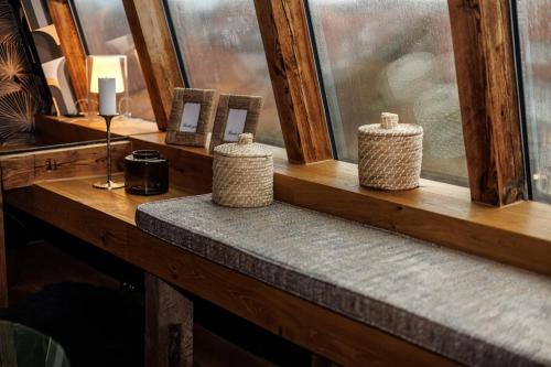 three vases sitting on a window sill in a room at Himmlisches Penthouse am Fischmarkt in Stade