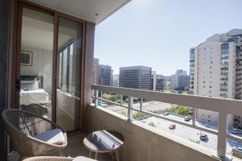 a balcony with two chairs and a view of a city at Spacious and Minimalist Apartment on Pentagon City in Arlington