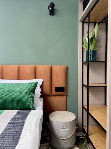 a bedroom with a bed with a brown headboard at JADE - guesthouse in Buzău