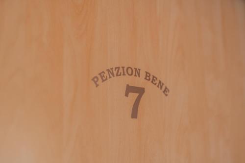 a sign on a wooden door with the number one at Penzion Bene in Chotěboř