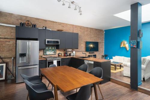 a kitchen with a wooden table and a dining room at Two bedroom duplex in Plateau Mont-Royal district in Montréal