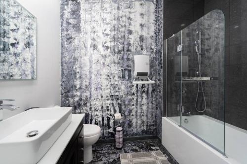 a bathroom with a sink and a toilet and a shower at Two bedroom duplex in Plateau Mont-Royal district in Montréal