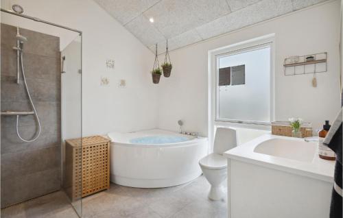a bathroom with a tub and a toilet and a sink at Lovely Home In Haderslev With Wifi in Haderslev