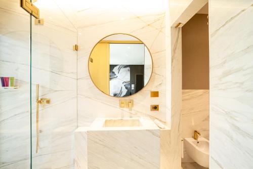 a bathroom with a sink and a mirror at The First Musica - Preferred Hotels & Resorts in Rome