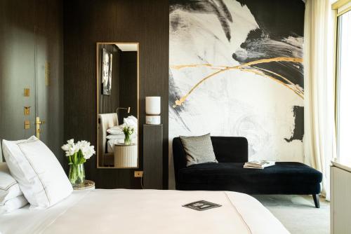 a bedroom with a bed and a couch at The First Musica - Preferred Hotels & Resorts in Rome