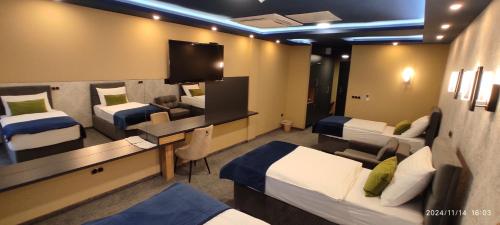 a room with two beds and a flat screen tv at HOTEL LOBBY in Bihać