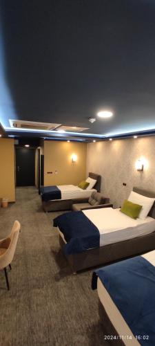 a hotel room with four beds in a row at HOTEL LOBBY in Bihać