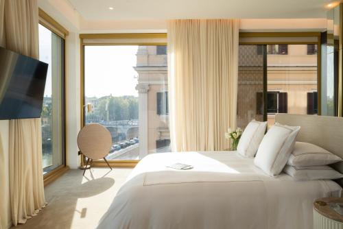 a bedroom with a large bed and a large window at The First Musica - Preferred Hotels & Resorts in Rome