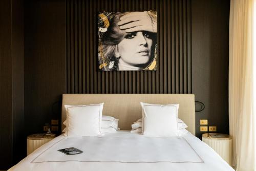 a bedroom with a bed with a picture on the wall at The First Musica - Preferred Hotels & Resorts in Rome