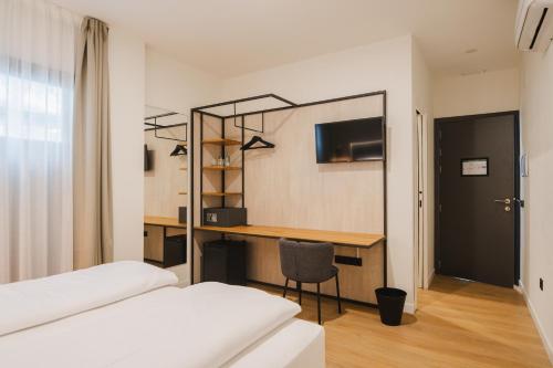 a room with two beds and a desk with a chair at Casa Cuatro Boutique Hotel - Adults Recommended in Novo Sancti Petri