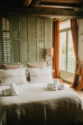 a bedroom with two large beds and a window at Mas el Mir in Ripoll