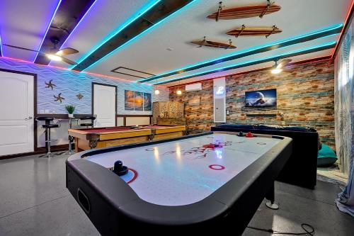 a room with a ping pong table and a pool table at Embrace Disney Magic at Our Luxe 6-BR Villa in ChampionsGate! in Davenport