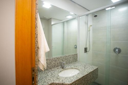 a bathroom with a sink and a shower at Flat Casa Mauá in Rio de Janeiro