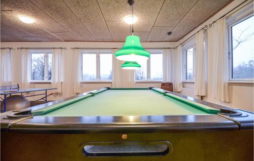 a pool table in a room with a ping pong ball at One-Bedroom Apartment In Ebeltoft in Ebeltoft