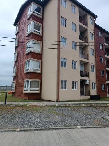 an apartment building on the side of a street at Departamento íntimo y de entorno natural. in Temuco