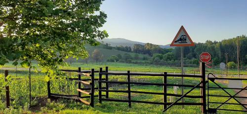 a fence and a stop sign in a field at Schaefers' Halt in Dullstroom
