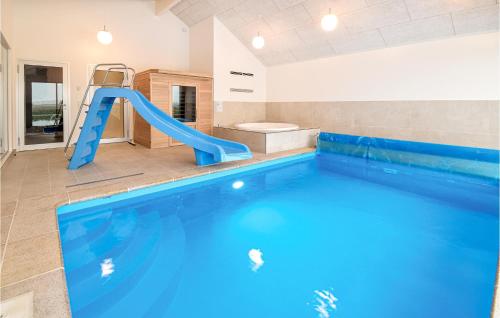a swimming pool with a slide in a bathroom at Beautiful Home In Otterup With Sauna in Otterup