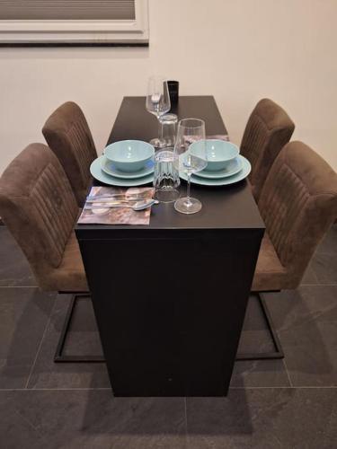 a table with plates and wine glasses on it at Het Uitzicht in Malden