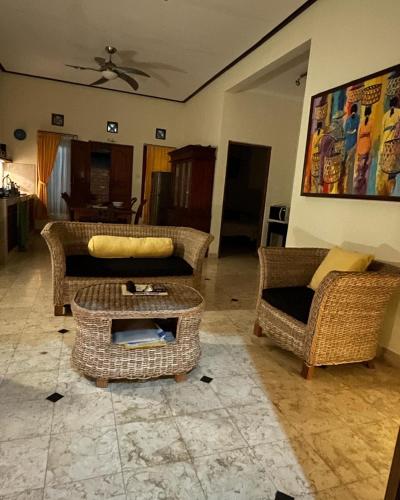 a living room with two couches and a table at Villa Mola Mola in Candidasa