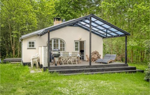 a small white cottage with a black roof at 2 Bedroom Gorgeous Home In Nykøbing Sj in Nykøbing Sjælland