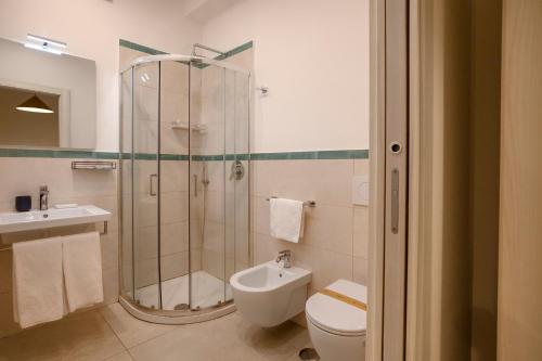 a bathroom with a shower and a toilet and a sink at Villa Pino in Furore