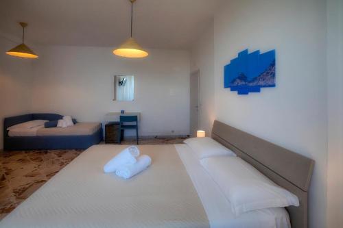 a bedroom with a large bed with white pillows at Villa Pino in Furore