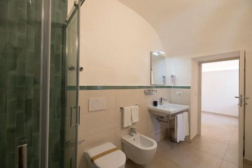 a bathroom with a toilet and a sink and a shower at Villa Pino in Furore