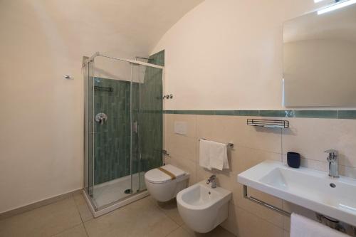 a bathroom with a shower and a toilet and a sink at Villa Pino in Furore
