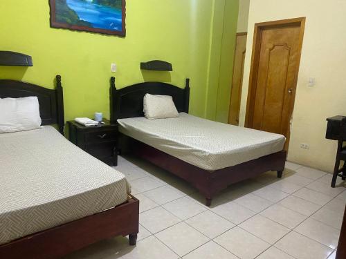 Postel nebo postele na pokoji v ubytování Hotel Real