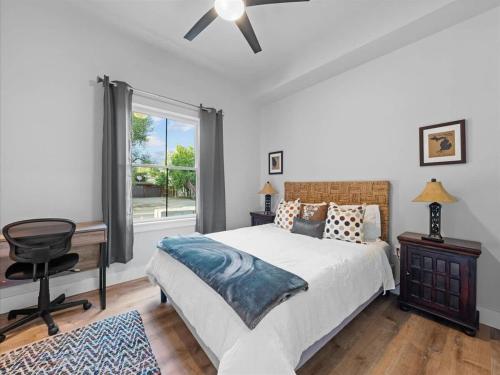 a bedroom with a bed and a desk and a window at 5 Bedroom - Located in Old Town Eagle in Eagle
