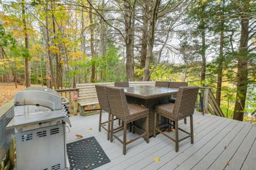 a table and chairs on a deck with a grill at 1 Mi to Acadia Home Near Downtown Bar Harbor! in Bar Harbor