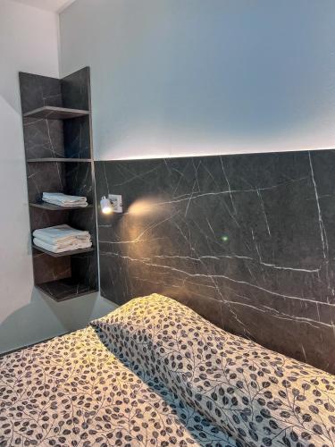 a bedroom with a bed and a black wall at Goleta Florencia 2045 in Ushuaia