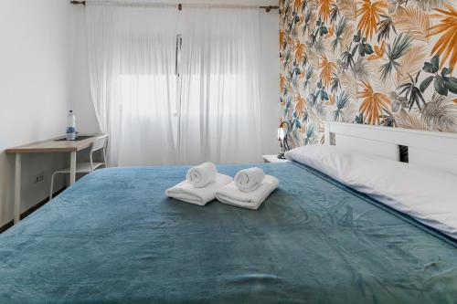 two towels sitting on top of a bed at Urban Nest Suites in Las Palmas de Gran Canaria