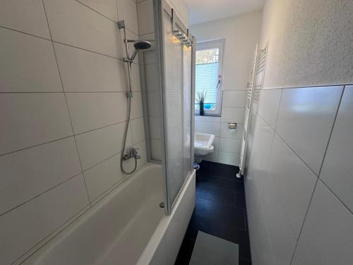 a bathroom with a shower and a sink at Ferienwohnung NORDLICHT mit Balkon und Smart-TV in Rostock